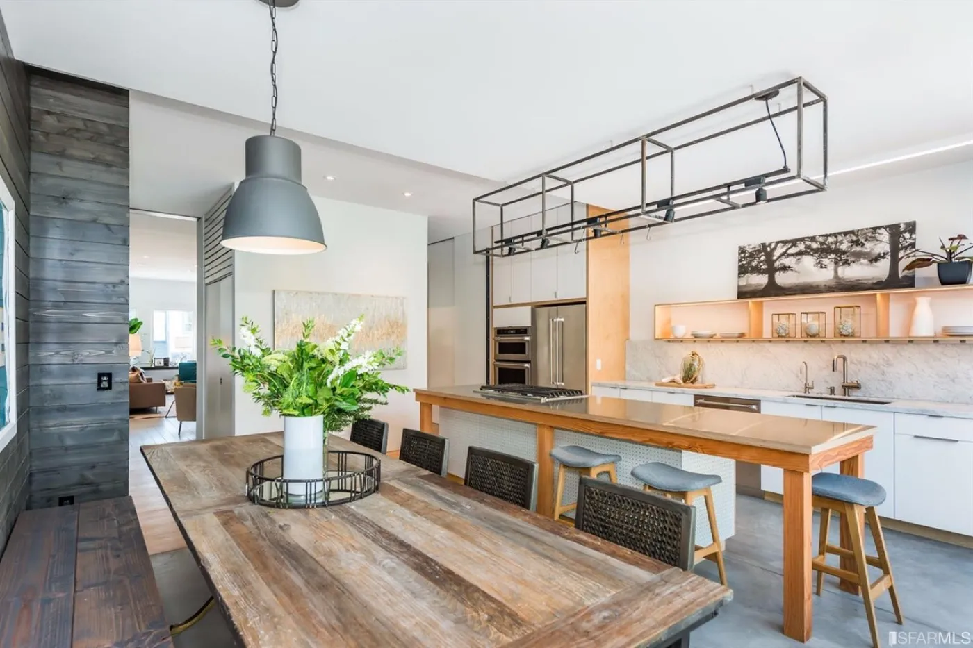 Kitchen-diner with a reclaimed timber dining table in front of a timber-framed island