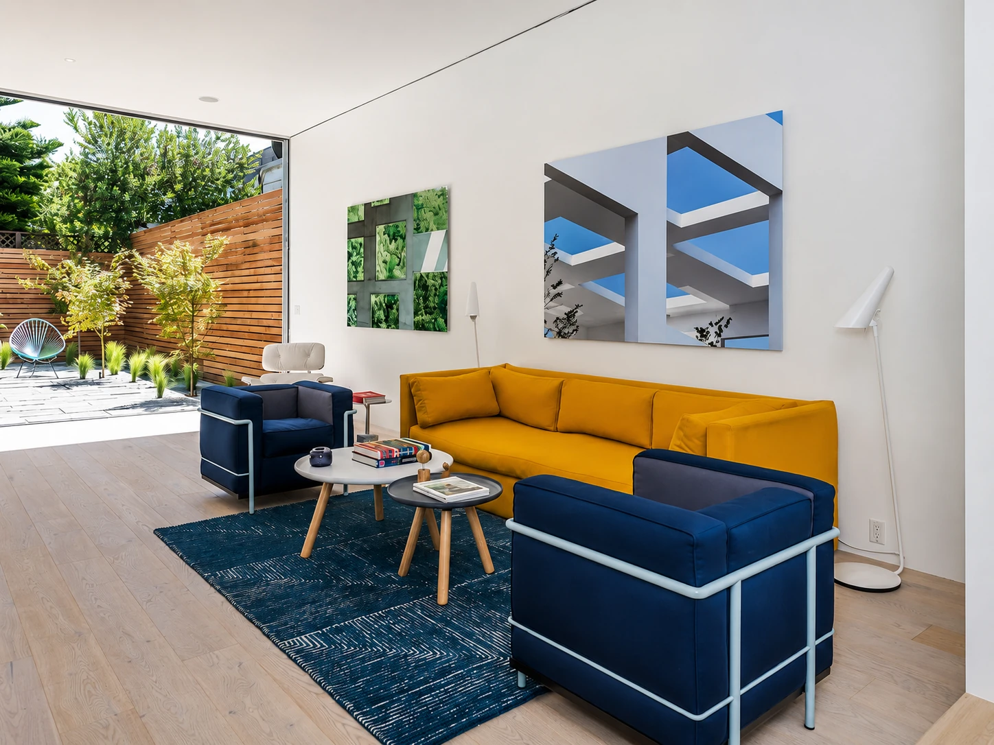 Open-plan living room opening onto a landscaped courtyard, part of a full property renovation by McGibbon Construction